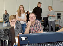 Konzentrierte Arbeit am Mischpult: Student Jonny Thumb und Professor Mike Winkler (v.l.). Hinten stehend Museumspädagogin Sabine Lienen-Kraft im Gespräch mit Philipp Neumayer, Akademischer Produktionsleiter Hörfunk an der Fakultät Medien.