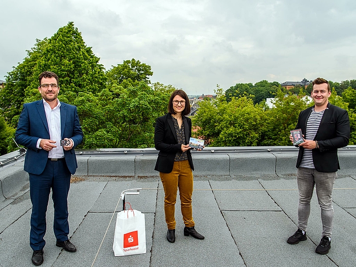 Gutscheine für den lokalen Einkauf als Teil eines großen Hilfsfonds für Studierende: Holger Nerlich von der Sparkasse Mittelsachsen (links) übergibt an Dr. Julia Köhler und Gordon Guido Oswald von der Hochschule Mittweida.