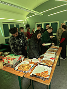 Students eating pizza and partying together