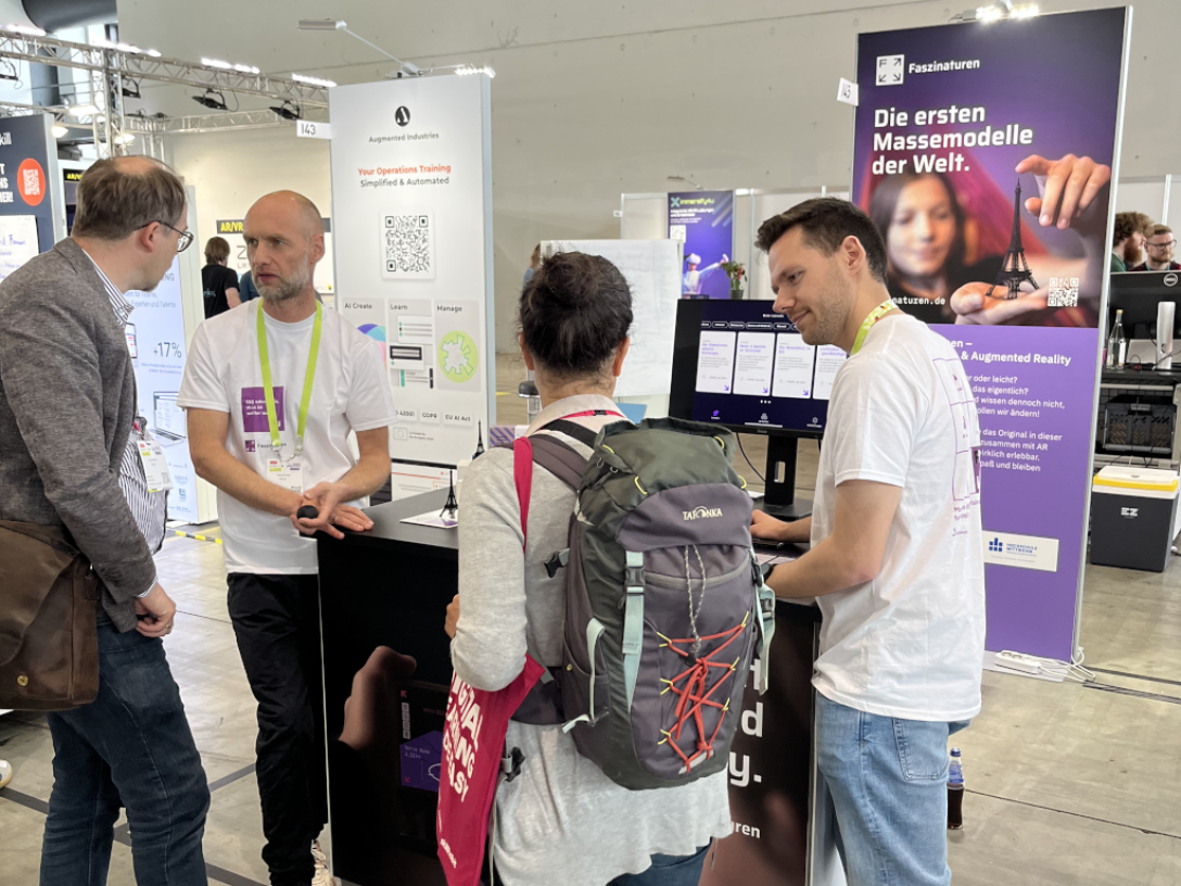 People are standing around an exhibition stand