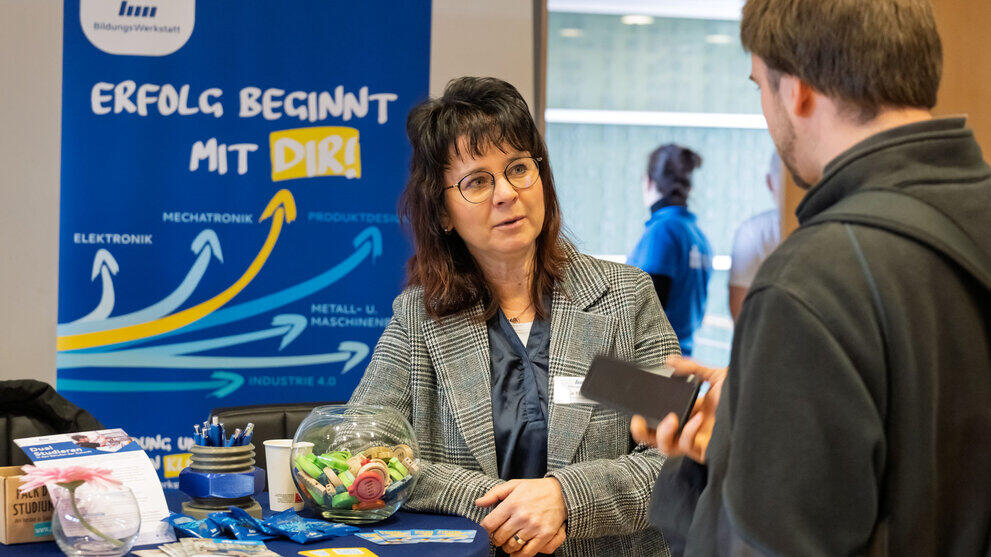 A woman standing in front of a roll-up banner reading ‘Success starts with you’