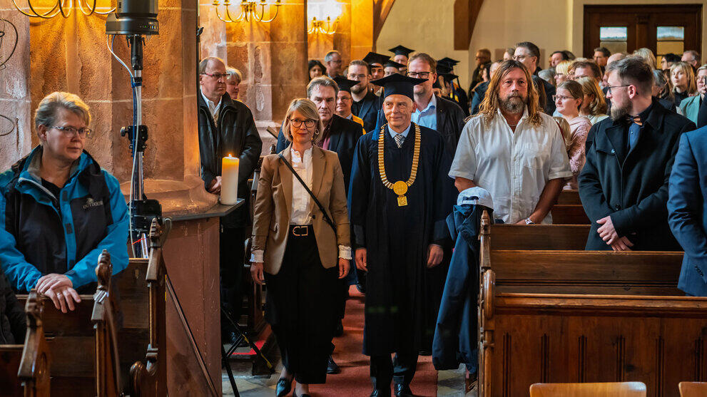 Procession of professors in academic robes and guests of honour down the central aisle of the nave.