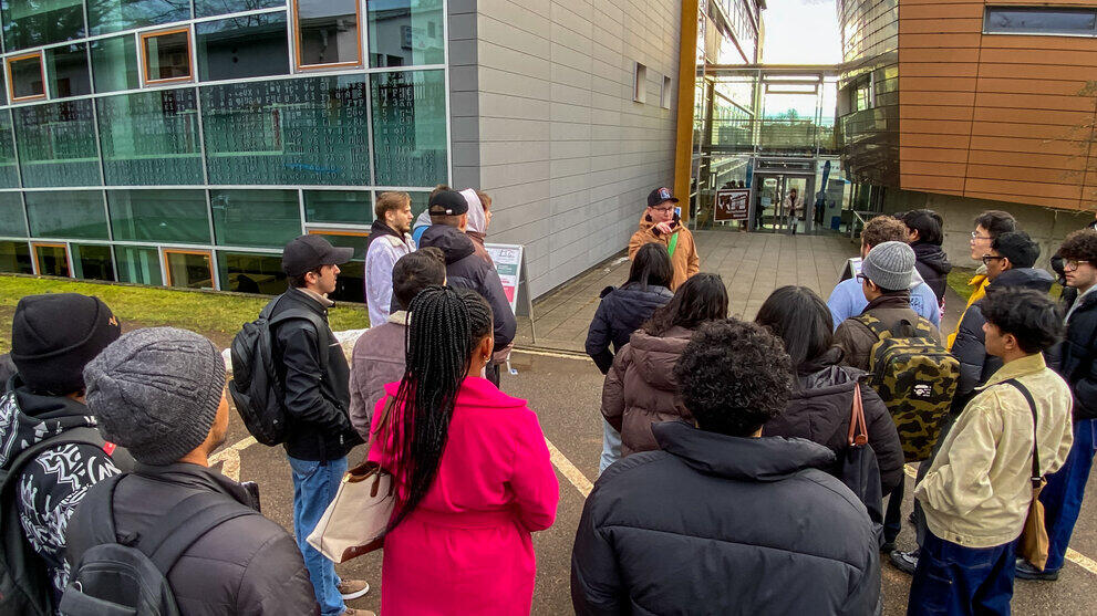 A group of people outside university buildings