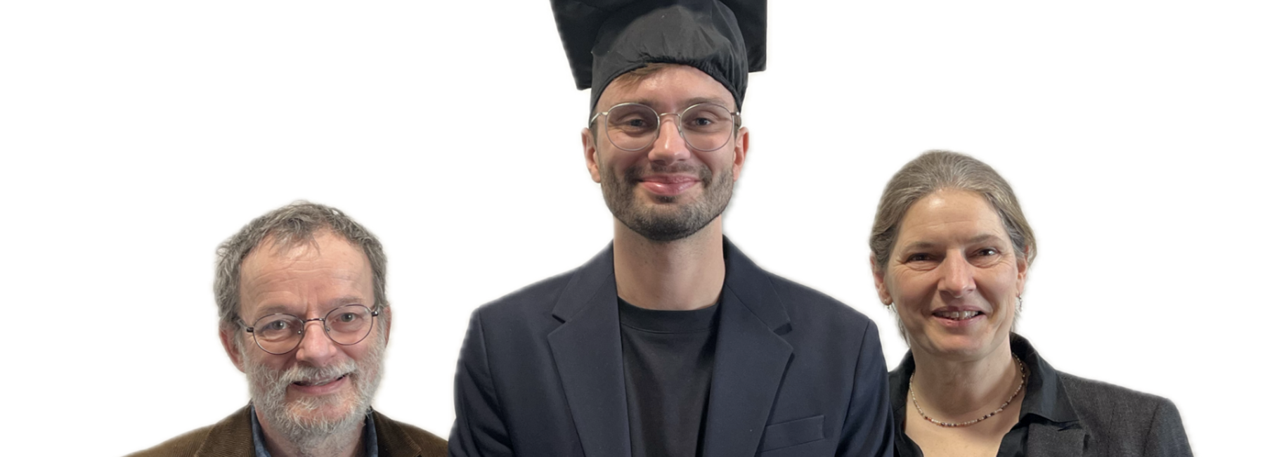 Two men and one woman are standing, smiling, against a white background; the man in the middle is wearing a doctoral cap