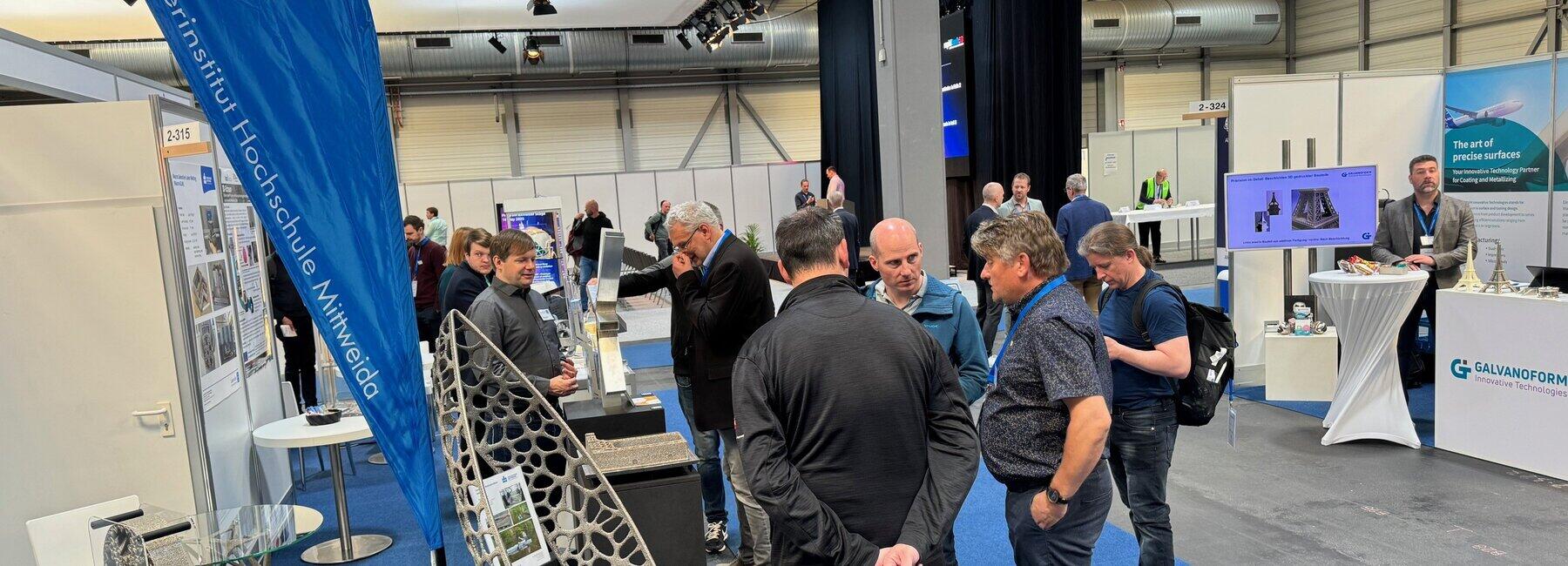 A view of an exhibition stand with visitors