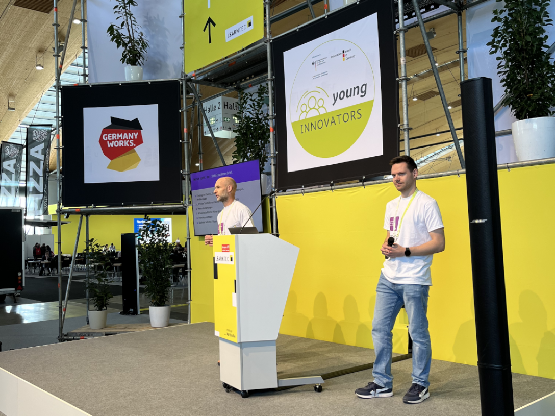 Two men are standing on a stage