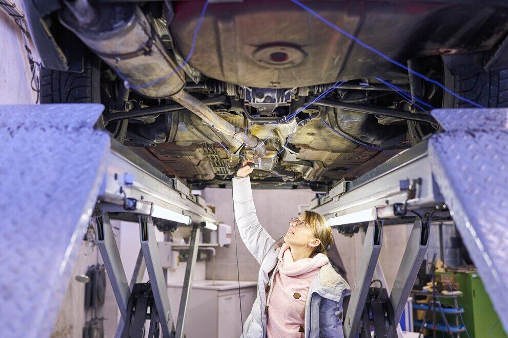 A student carries out an acoustic measurement on the vehicle