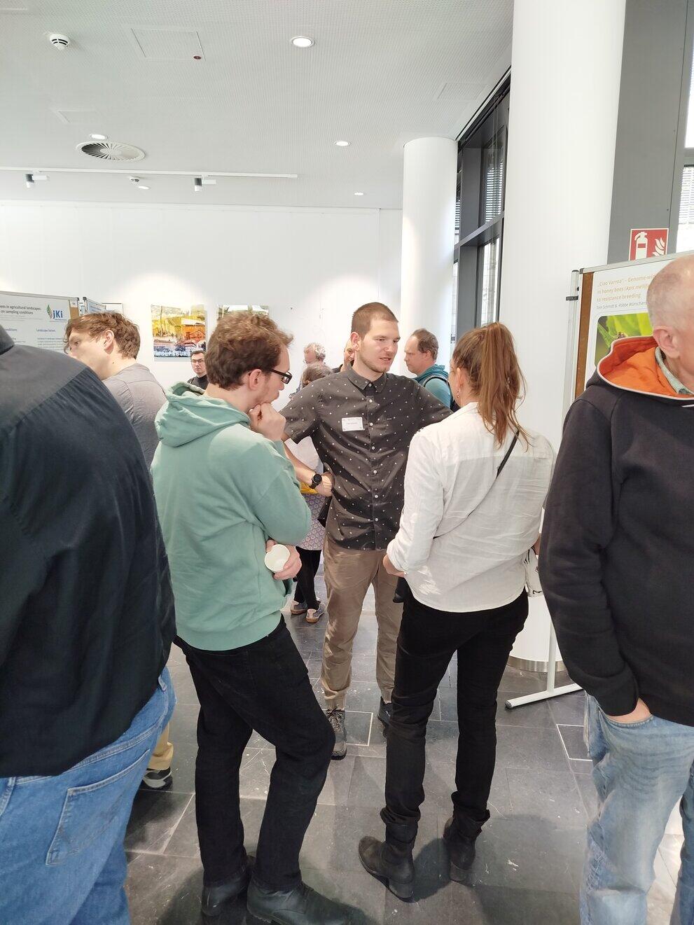 People are standing around someone who is explaining