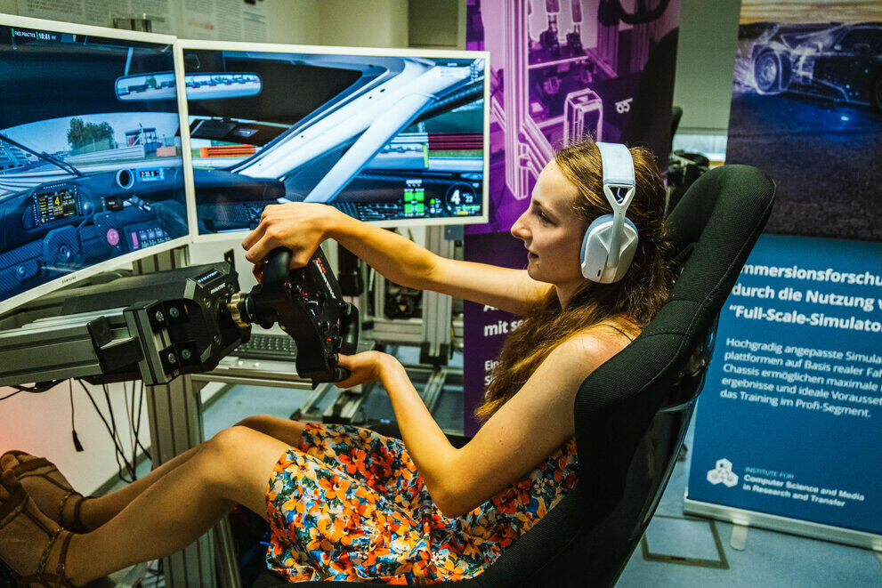 In the Living Lab, a visitor is trying out the driving simulator.