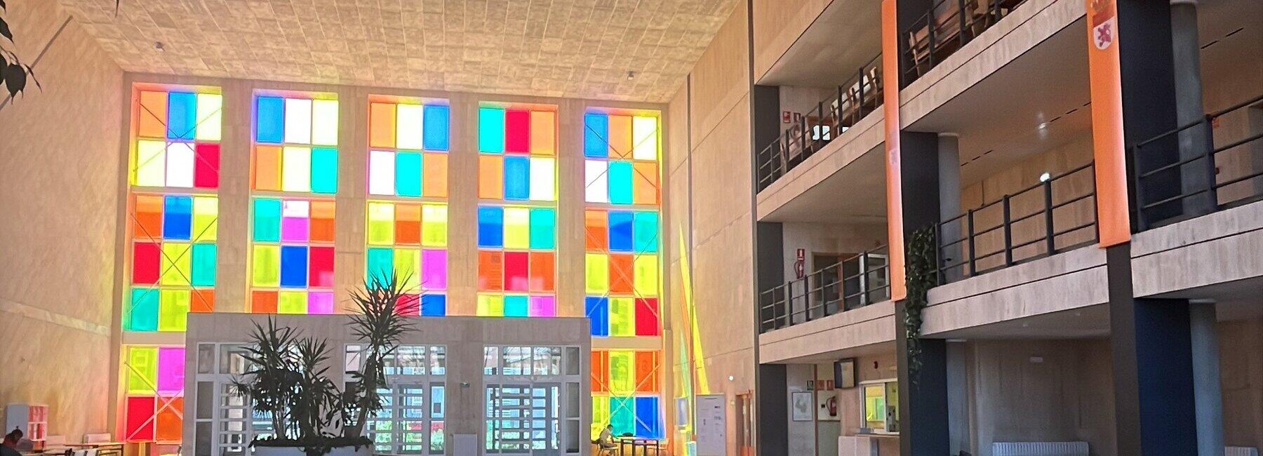 A view into a building with a colourful row of windows
