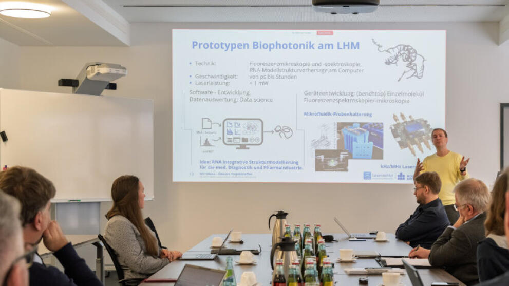 männliche Person steht vor Präsentationswand